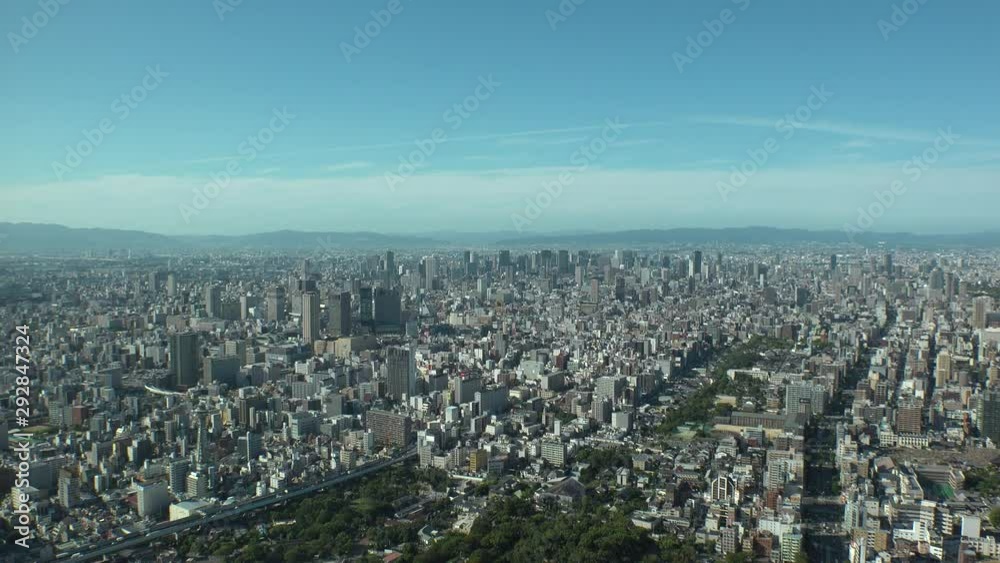 OSAKA, JAPAN - CIRCA SEPTEMBER 2019 : Aerial high angle view of CITYSCAPE of OSAKA in daytime. Osaka is the second largest metropolitan area in Japan. Zoom in shot. OSAKA, JAPAN - CIRCA SEPTEMBER 2019 : Aerial high angle view of CITYSCAPE of OSAKA in daytime. Osaka is the second largest metropolitan area in Japan. Zoom in shot.