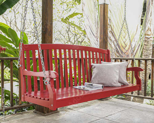 The red wood swing in the backyard.