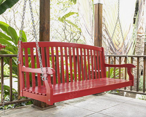 The red wood swing in the backyard.