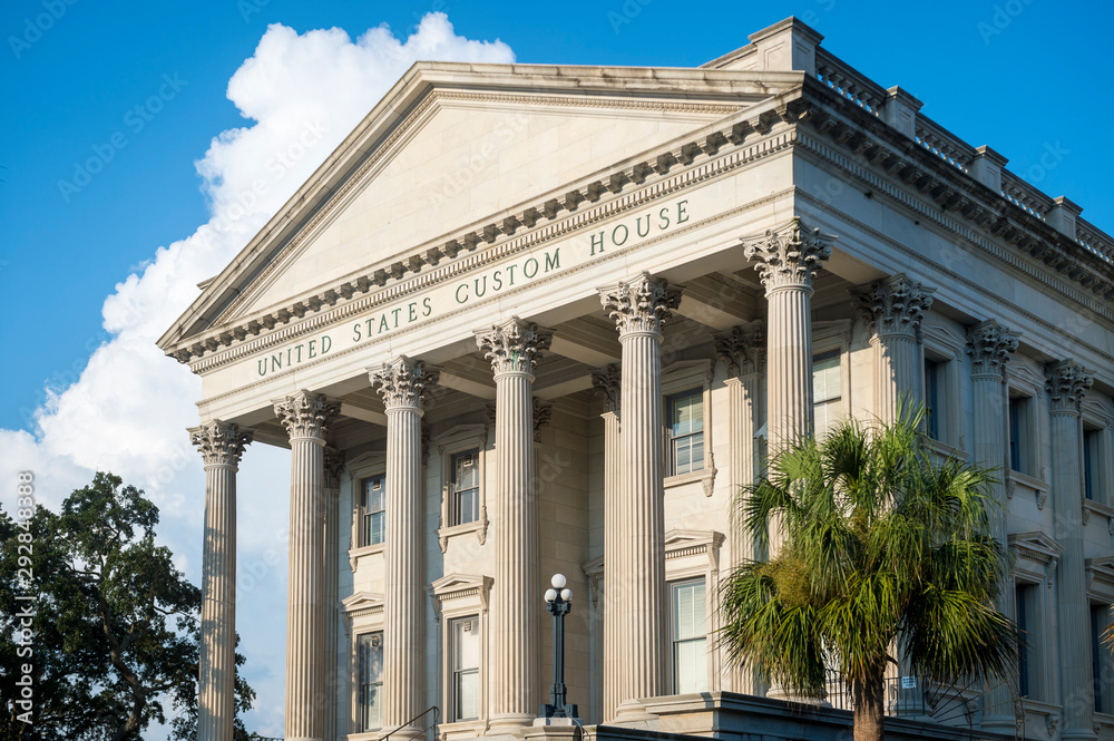 Scenic afternoon view of the neoclassical United States Custom House building with palmetto palm trees in Charleston, South Carolina, USA