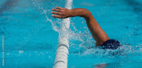 Swim competition swimmer athlete doing crawl stroke in swimming pool