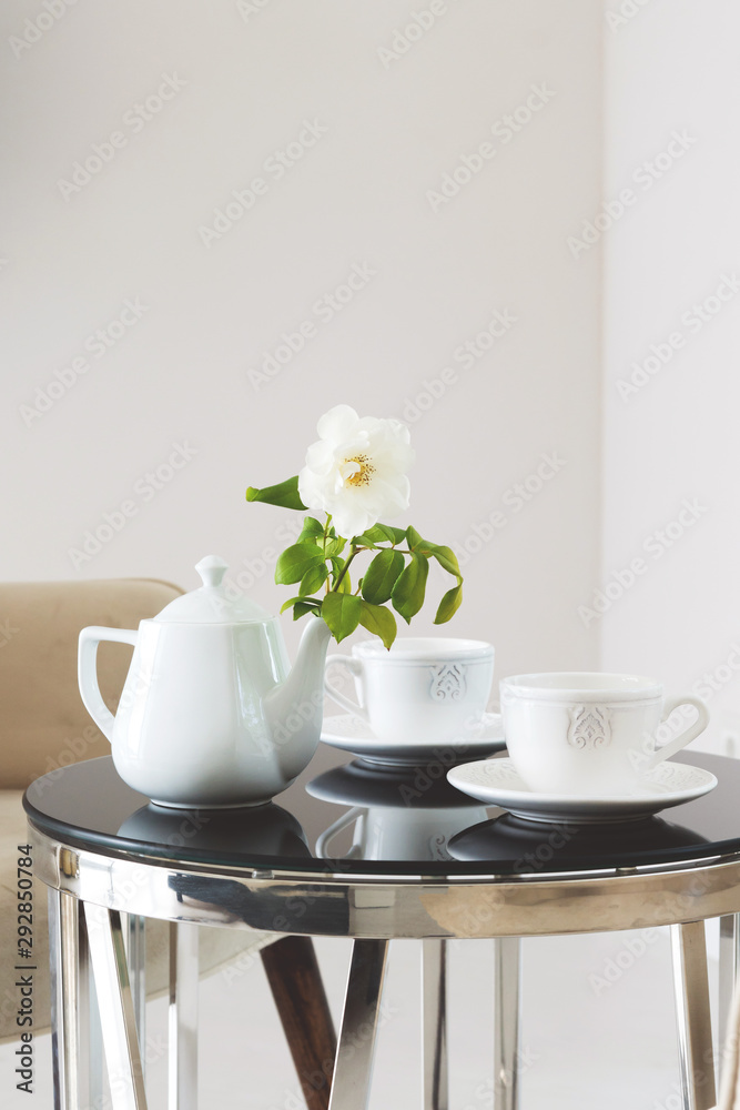 Two cups and tea cattle on a table. Two cups and tea cattle on a table.