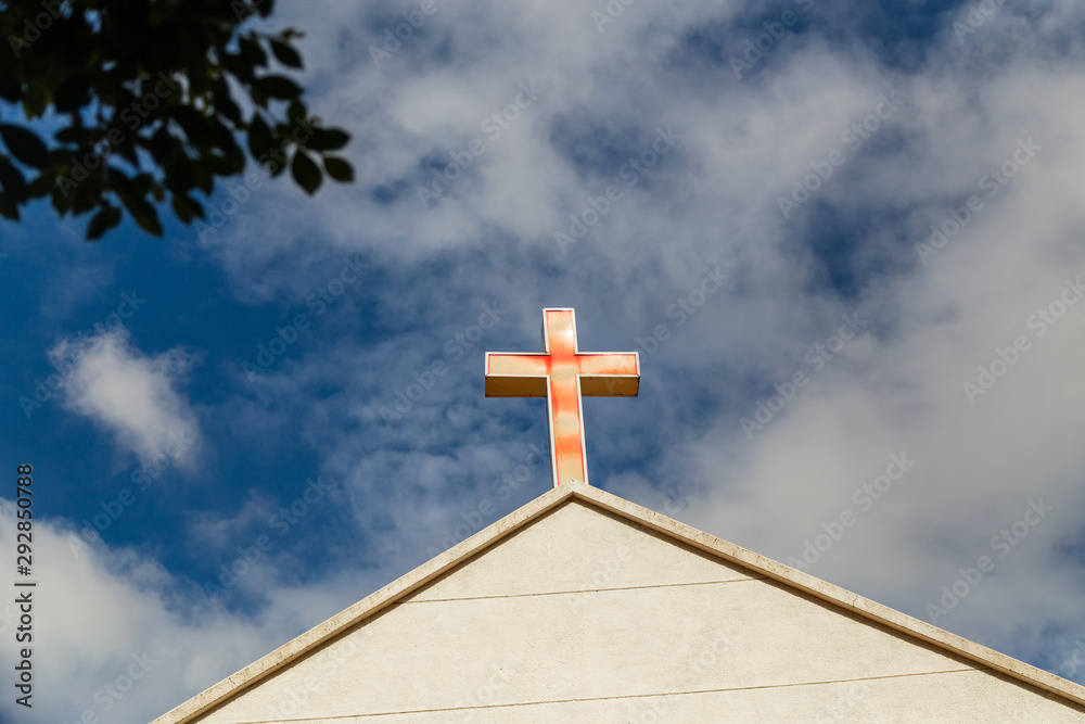 Faded cross on church roof