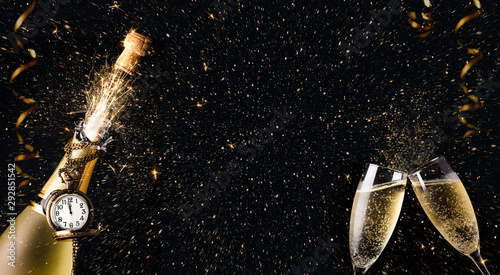 New year celebration party with champagne bottle and glasses toasting