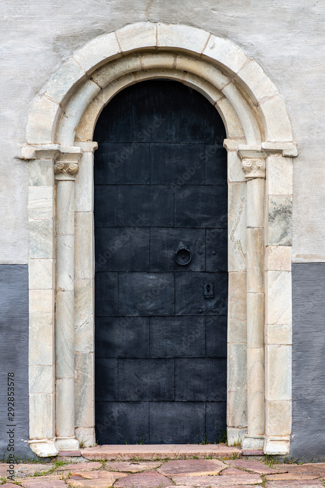 Black vaulted door with pillars from an old church in Sweden