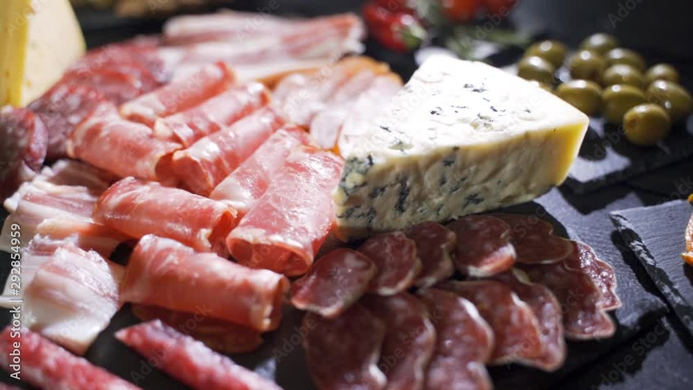 Video of italian meat plate - sliced prosciutto, sausage and cheese Video of italian meat plate - sliced prosciutto, sausage and cheese