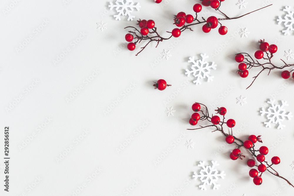 Christmas or winter composition. Snowflakes and red berries on gray background. Christmas, winter, new year concept. Flat lay, top view, copy space Christmas or winter composition. Snowflakes and red berries on gray background. Christmas, winter, new year concept. Flat lay, top view, copy space