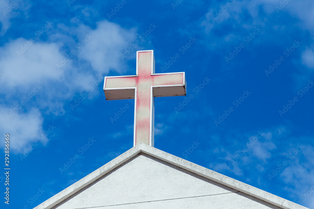 Faded cross on church roof