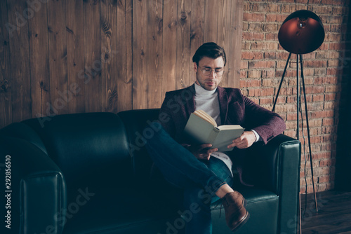 Photo of macho business guy holding hands corporate book reading article about famous chiefs wear specs stylish blazer turtleneck sitting couch modern office