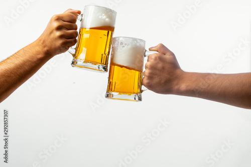 Hands toasting with beer on white background