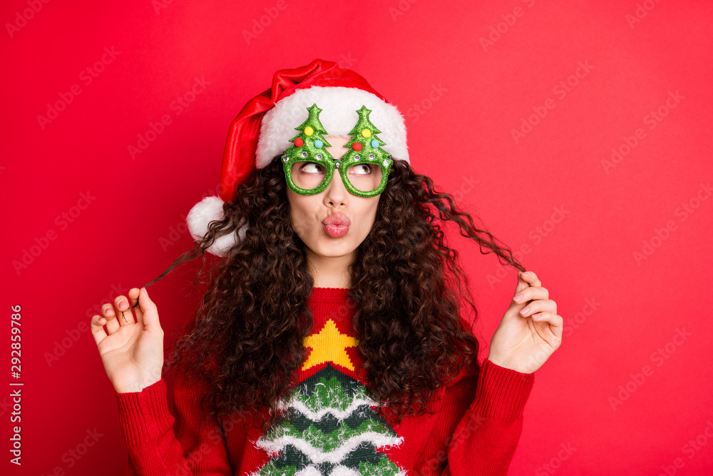 Close-up portrait of her she nice-looking attractive lovely pretty cheerful flirty wavy-haired Santa girl pouted lips playing with curls isolated over bright vivid shine vibrant red color background