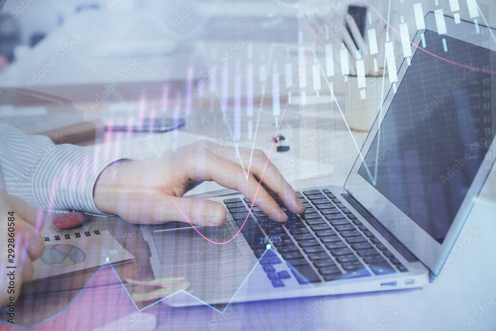 Multi exposure of stock market graph with man working on laptop on background. Concept of financial analysis. Multi exposure of stock market graph with man working on laptop on background. Concept of financial analysis.