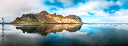 Splendid sunny day and gorgeous reflection of Vestrahorn mountaine on Stokksnes cape in Iceland. photo