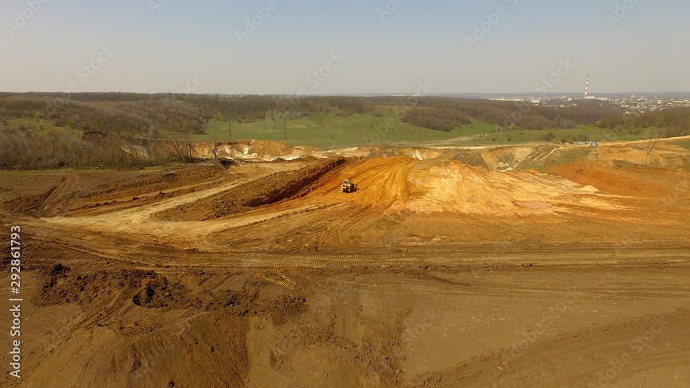 Aerial view of sand quarry with bulldozer