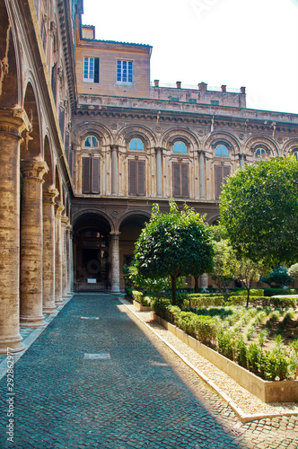 A well-kept green courtyard with trees and a fountain in the Doria Pamphili Gallery at Via del Corso, 305, Rome, Italy