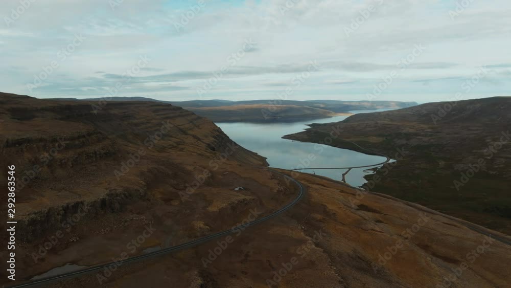 Aerial approaching view of a volcanic mountain and a fjord in West Iceland Aerial approaching view of a volcanic mountain and a fjord in West Iceland
