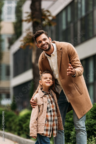 happy father and son embracing on street in autumn day © LIGHTFIELD STUDIOS