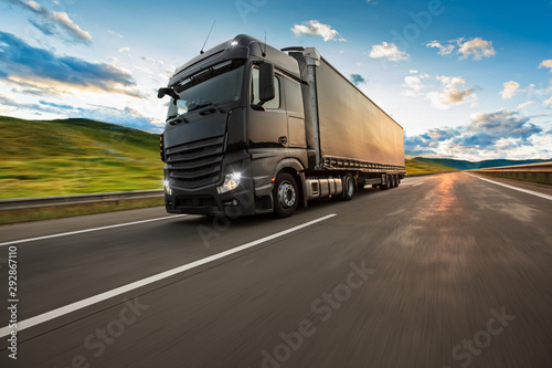 Truck with container on highway  cargo transportation concept. Shaving effect.