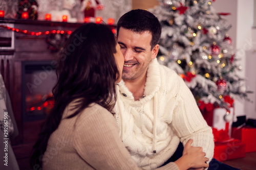 Photo of young husband smiling at his wife in christmas day © DC Studio
