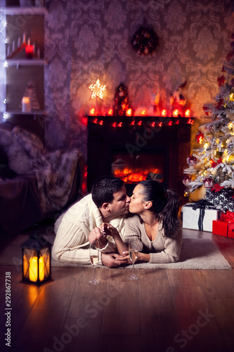 Attractive young couple celebrating christmas near christmas tree