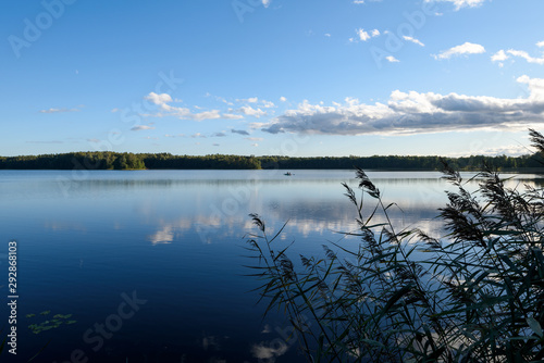 Sunset on the lake. Beautiful sunset nature. Evening landscape. Clouds over the lake.