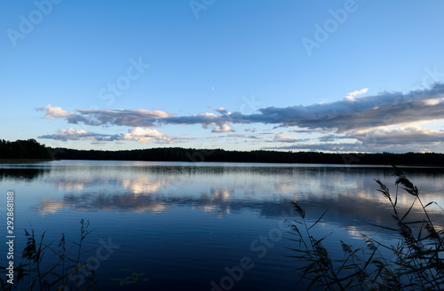 Sunset on the lake. Beautiful sunset nature. Evening landscape. Clouds over the lake.