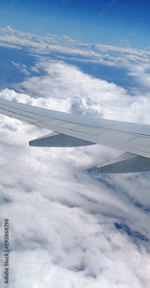 Obraz premium aerial view of white clouds from a plane window 