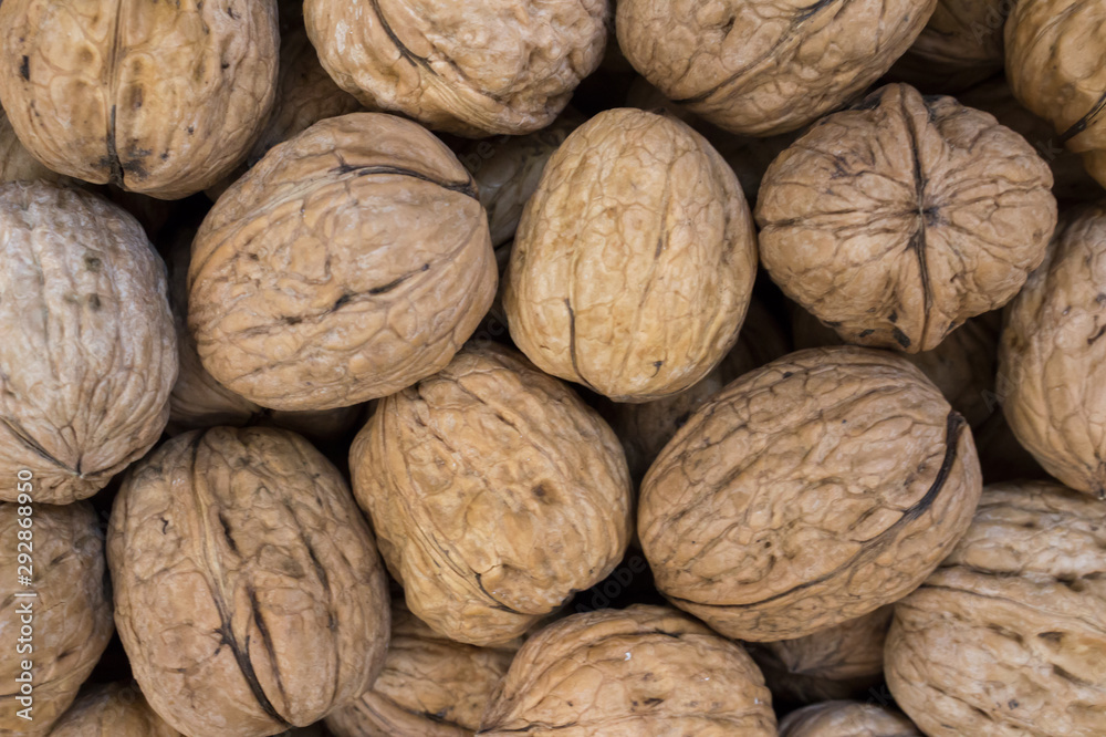 Whole walnuts on the market counter, background Whole walnuts on the market counter, background