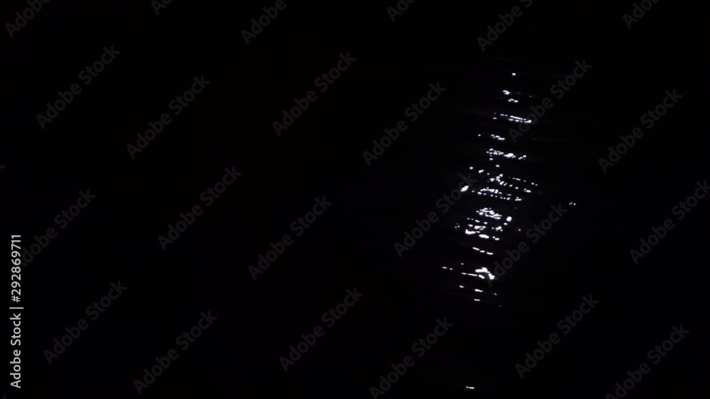 Ripples on the water. Dark night. Black color. Light from the moon. Ripples on the water. Dark night. Black color. Light from the moon.