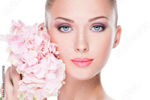 Closeup face of young beautiful woman with a pink makeup of eyes.
