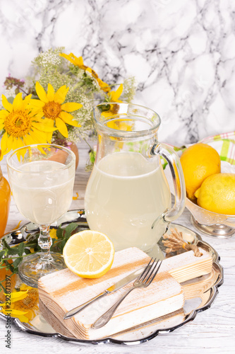 Refreshing drink with lemon and honey on a tray