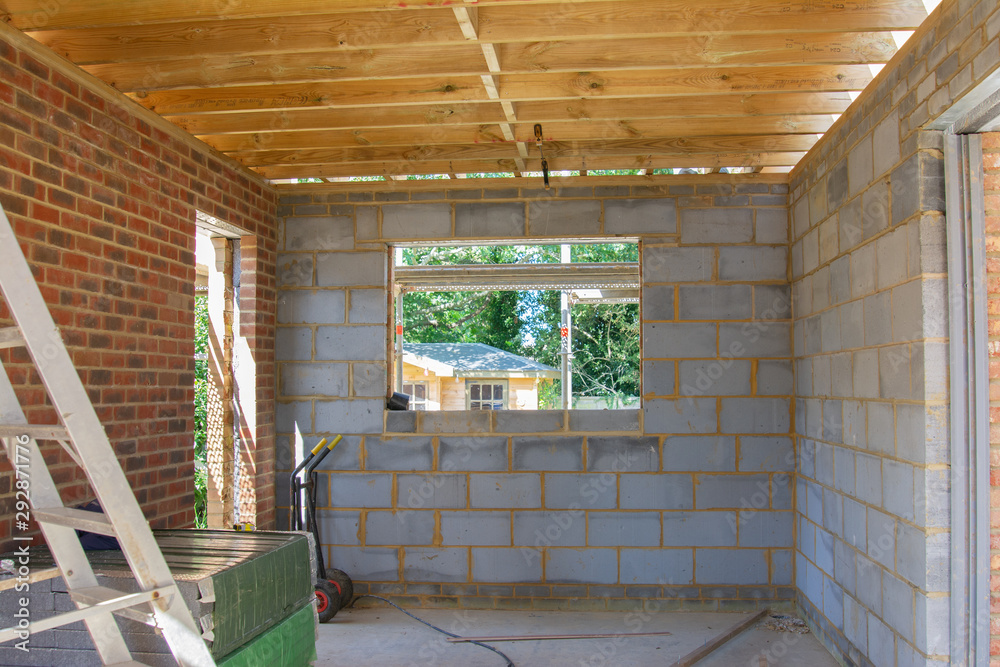 Fototapeta premium Residential renovation project unfinished garage in building blocks, roof structure