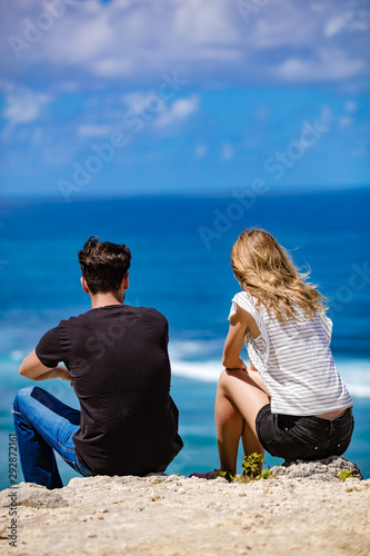 Couple looking at a tropical ocean / sea scenery.