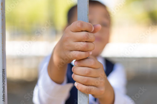 schoolboy holds cell and hopes for freedom or makes fun of the concept of life imprisonment