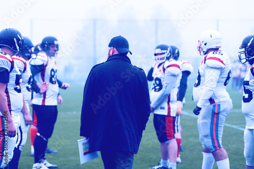 american football players discussing strategy with coach © .shock