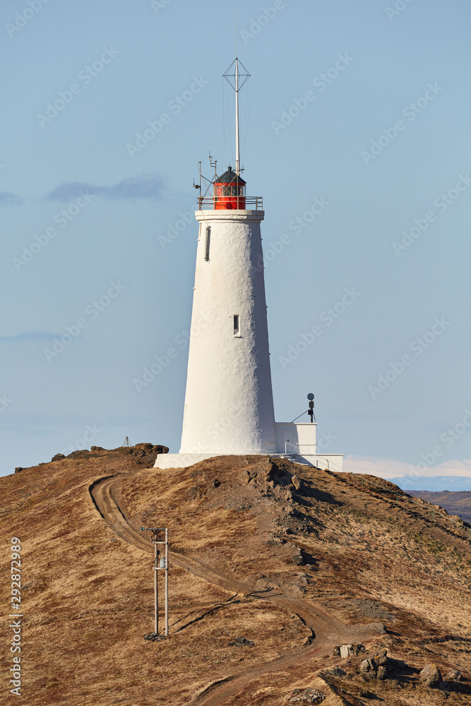 Reykjanes Lighthouse in Iceland with Gunnuhver geotermal area in the background