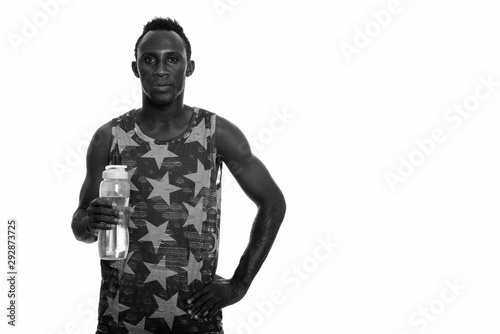Young black African man holding water bottle