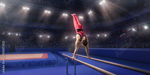 Male athlete doing a complicated exciting trick on parallel bars in a professional gym. Man perform stunt in bright sports clothes photo