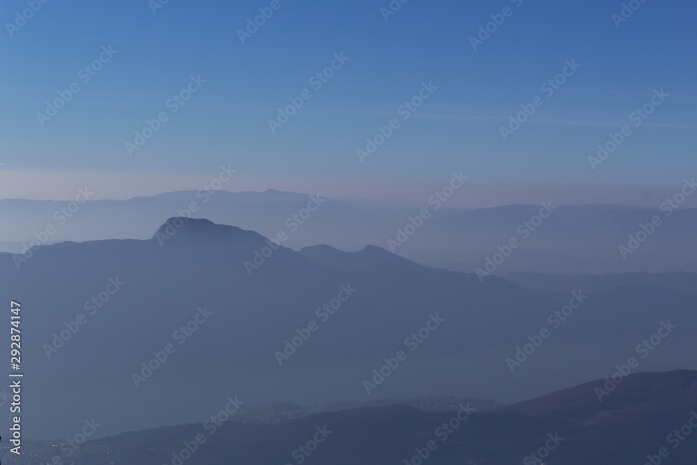 french alps mountains in winter snow fog  savoie region france