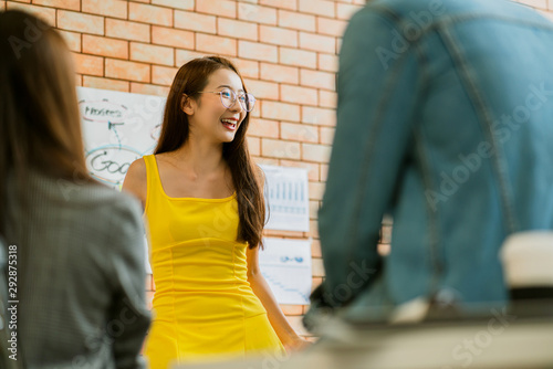 asian smart yellow dress Businesswoman leading presentation in conference room photo