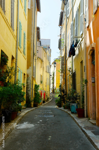 Fototapeta Naklejka Na Ścianę i Meble -  street  of mediterranean village with colorful shutter in the south of france,provence