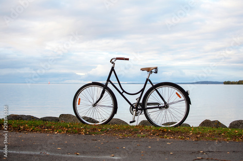 Bike by the water in the fall.