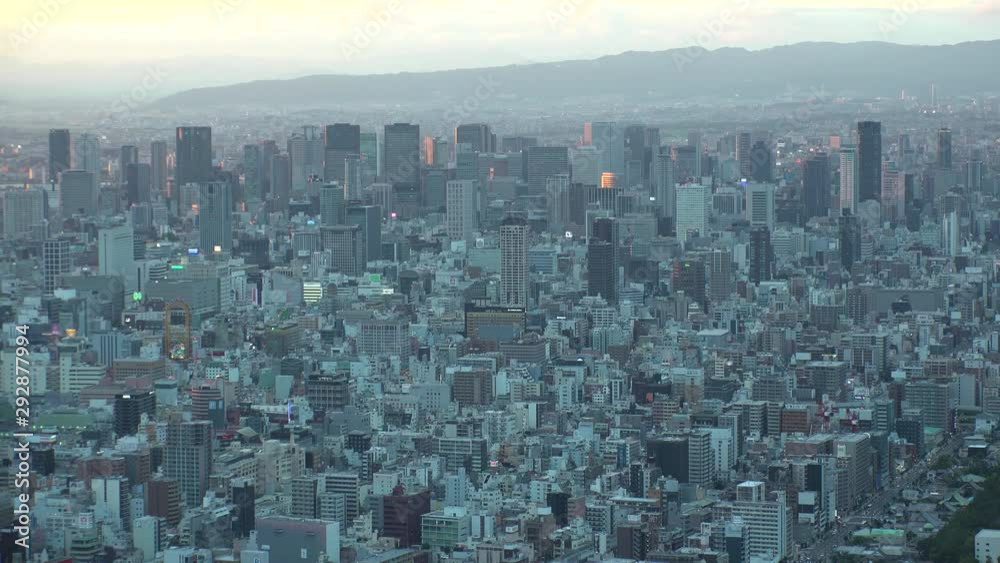 OSAKA, JAPAN - CIRCA SEPTEMBER 2019 : Aerial high angle view of CITYSCAPE of OSAKA. Time lapse shot, sunset to night. Osaka is the second largest metropolitan area in Japan. OSAKA, JAPAN - CIRCA SEPTEMBER 2019 : Aerial high angle view of CITYSCAPE of OSAKA. Time lapse shot, sunset to night. Osaka is the second largest metropolitan area in Japan.