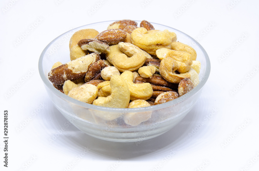 A small glass bowl of roasted and salted mixed nuts. A small glass bowl of roasted and salted mixed nuts.