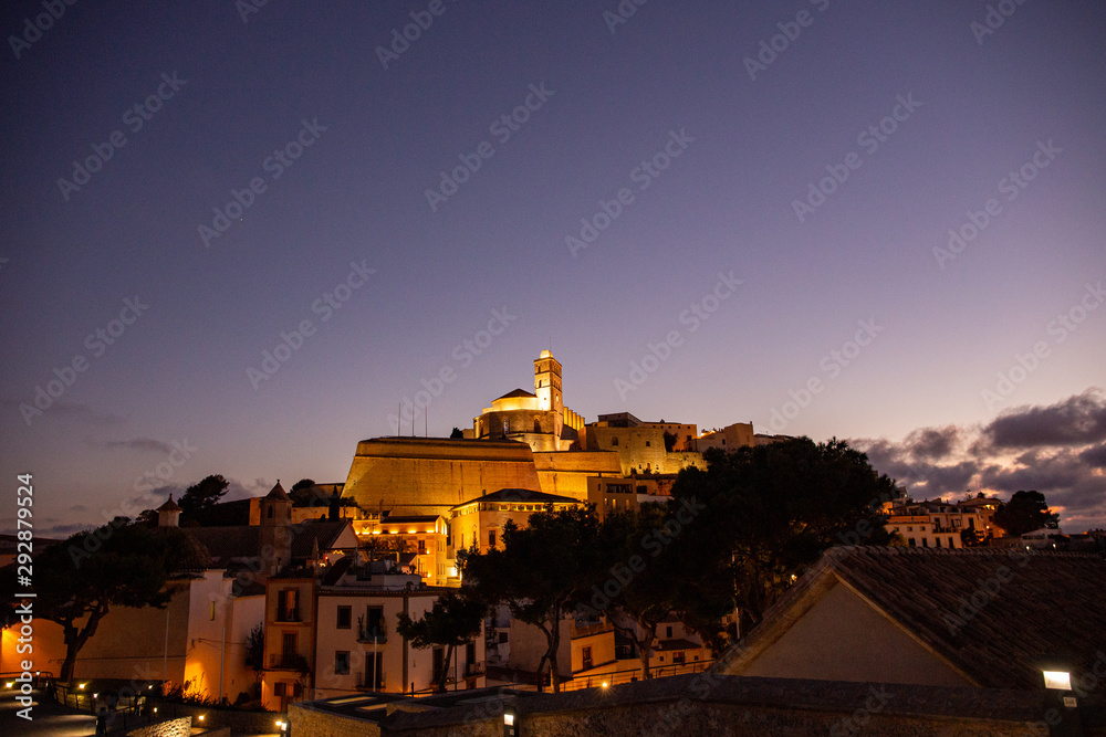 Obraz premium Walking in Ibiza's medieval age old town and fortress Dalt Vila, in Ibiza Town: the cathedral and castle and the magic of the night lights
