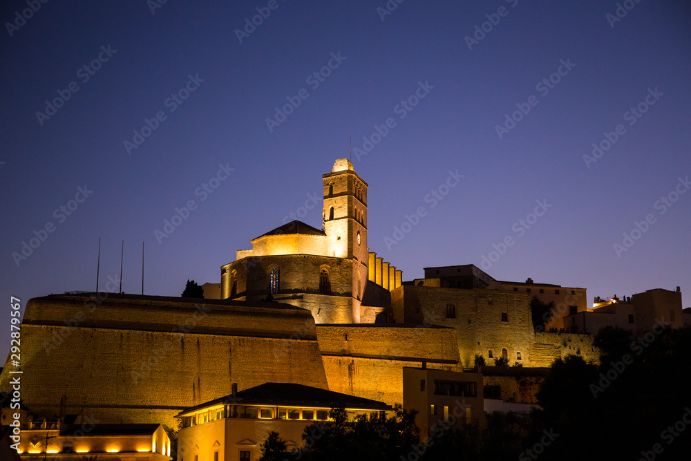 Walking in Ibiza's medieval age old town and fortress Dalt Vila, in Ibiza Town: the cathedral and castle and the magic of the night lights