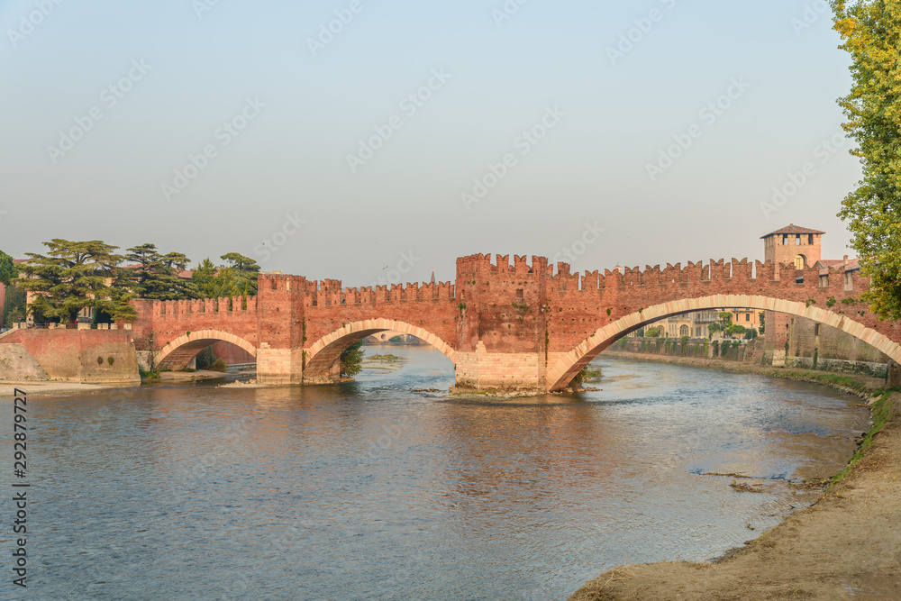 Adige River and fortified bridge Verona Castel Vecchio Bridge or Ponte Scaligero. Verona, Italy.