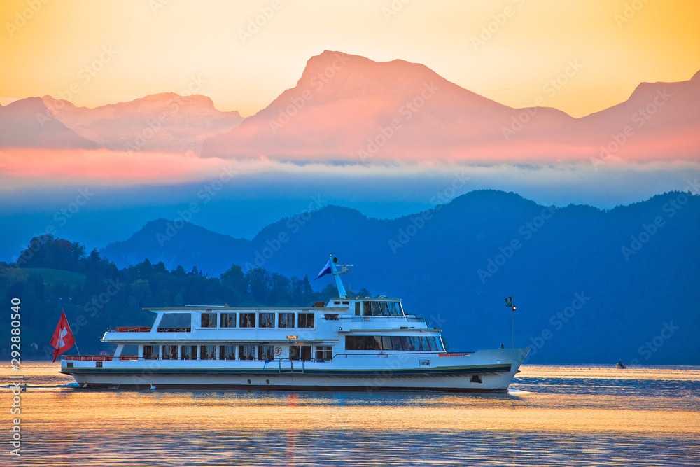 Lake Lucerne golden dawn boat and mountain peaks view,