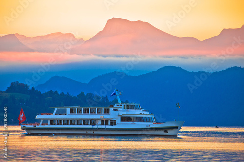 Fototapeta Naklejka Na Ścianę i Meble -  Lake Lucerne golden dawn boat and mountain peaks view,