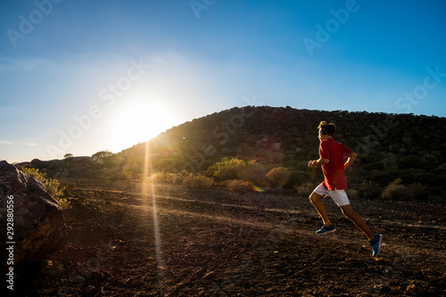 caucasian teenager running in mountain to be fitness boy and or lose weight - jogger and climber lifestyle - beautiful sunset © Daniel